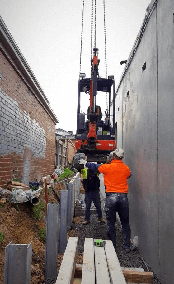 tight access excavation works, crane lowering in excavator